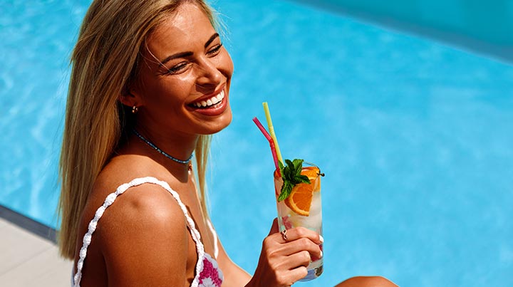 summer drink by pool woman smiling